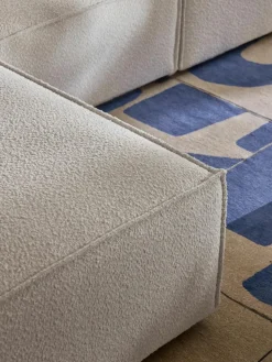 Modulaire bank Lennon (4-zits) uit bouclé met poef (links/rechts)