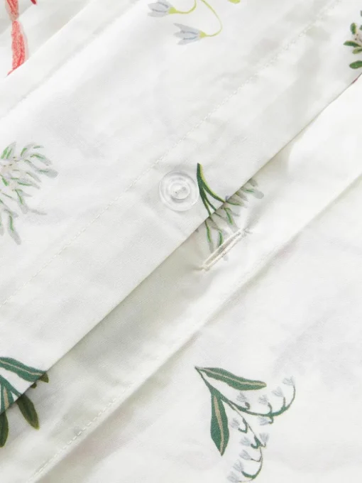 Omkeerbare katoenen perkale kussenhoes Twigs met winterse prints